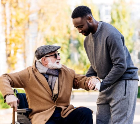 male caregiver helping senior man